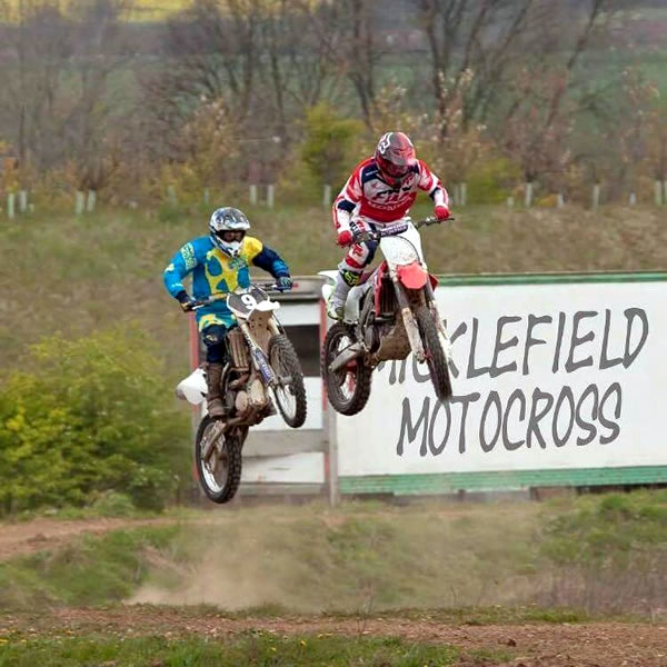 Pair of motocross bikes in mid air